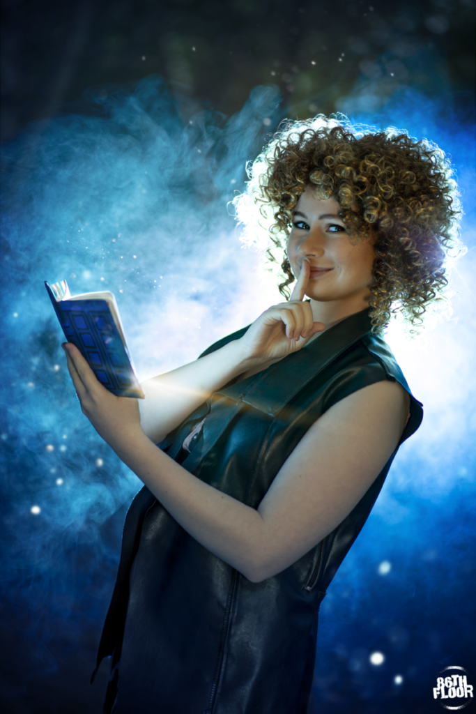 River Song cosplayer holding a Tardis Notebook